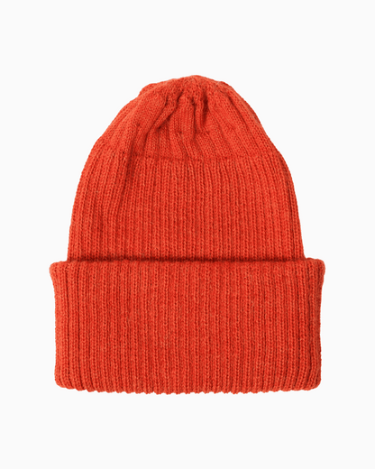 A ribbed alpaca knit beanie hat in a orange color, shown flat against a solid white background.