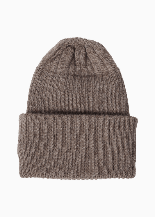 A ribbed alpaca knit beanie hat in a taupe brown color, shown flat against a solid white background.