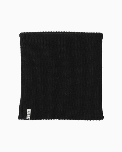 packshot of a folded black alpaca knitted neck warmer against a white background