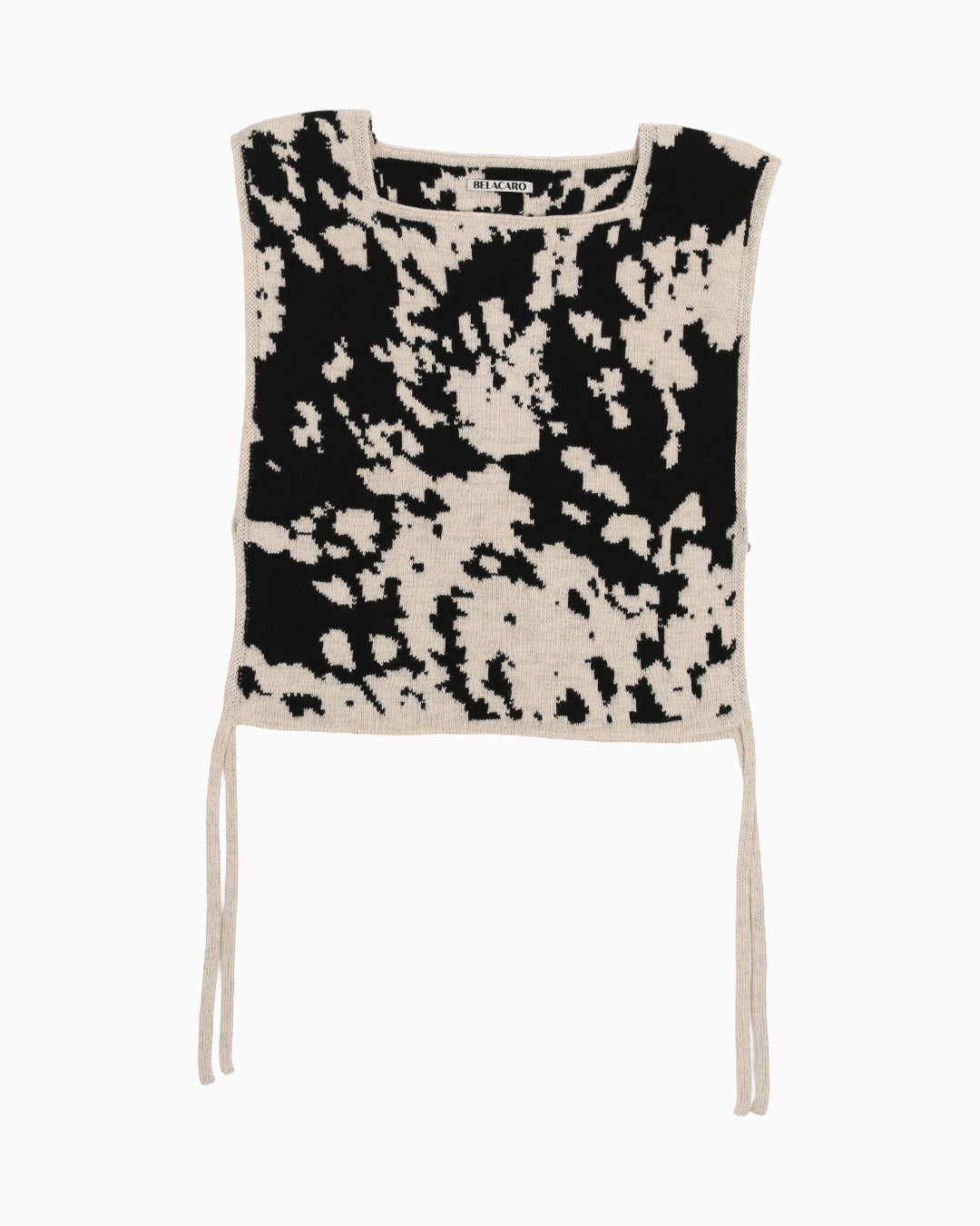 Black and white cow patterned sleeveless top on a white background