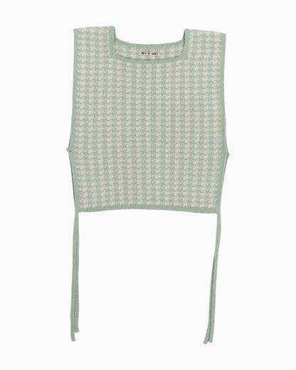 Green and white houndstooth knitted top on a white background