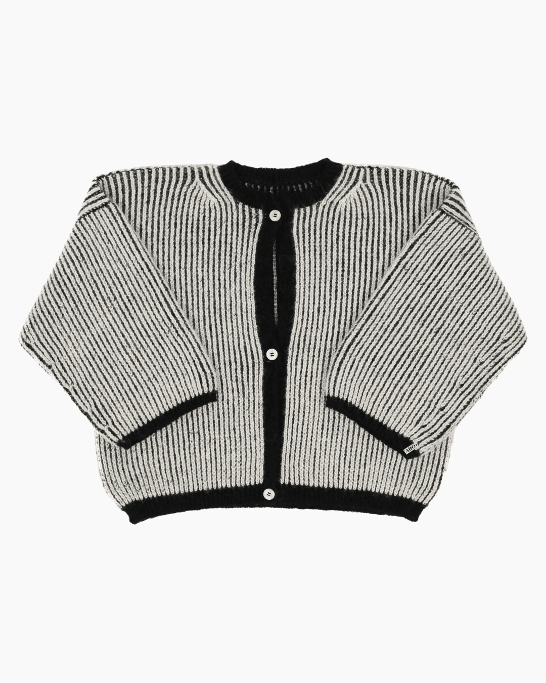 A bicolor black and white cardigan with a ribbed texture, 3 buttons down the front and wide 3/4 sleeves