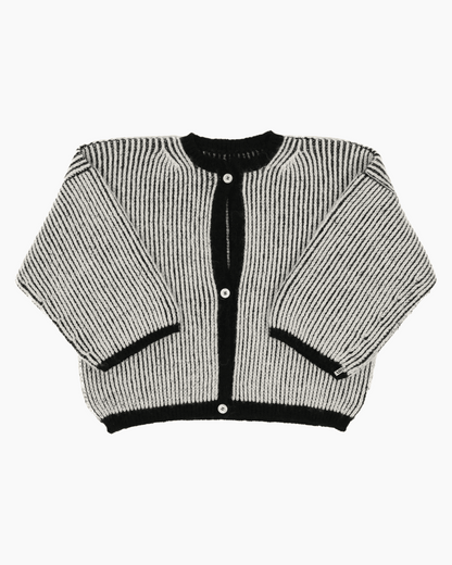 A bicolor black and white cardigan with a ribbed texture, 3 buttons down the front and wide 3/4 sleeves