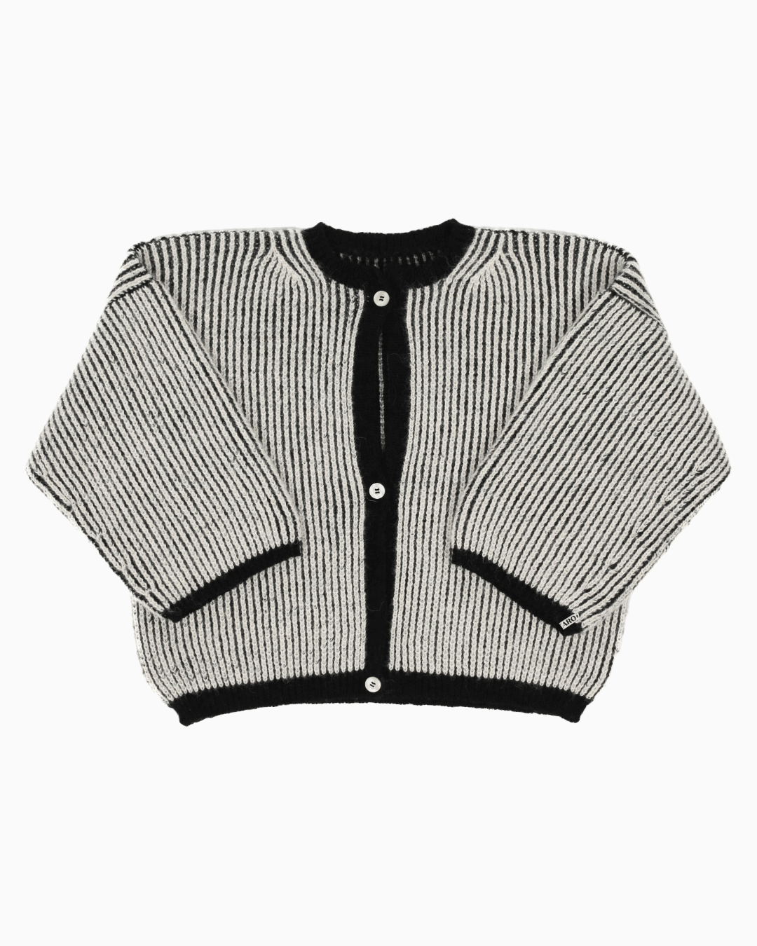 A bicolor black and white cardigan with a ribbed texture, 3 buttons down the front and wide 3/4 sleeves