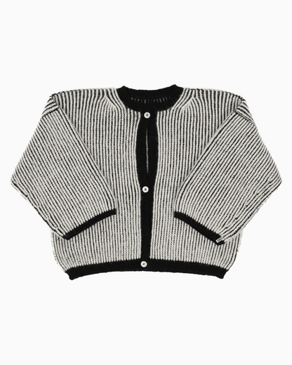 A bicolor black and white cardigan with a ribbed texture, 3 buttons down the front and wide 3/4 sleeves