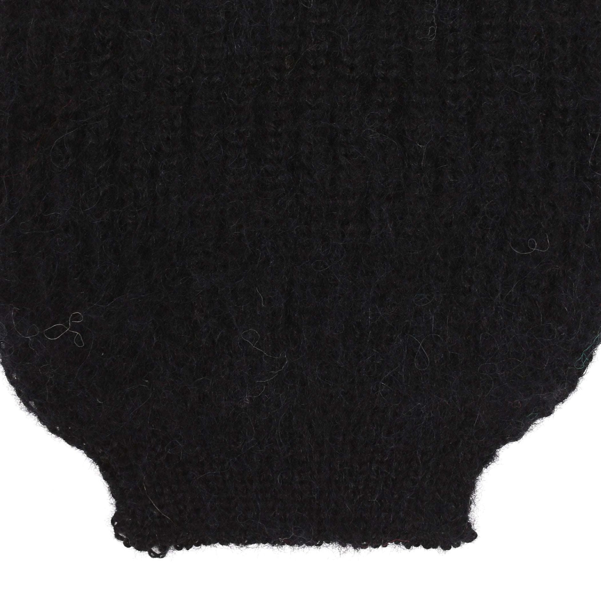 the sleeve detail of an alpaca ribbed knit black sleeve