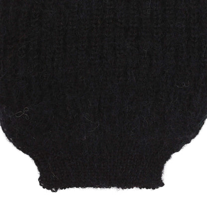 the sleeve detail of an alpaca ribbed knit black sleeve
