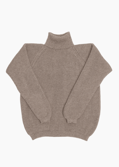 A beige unisex turtleneck sweater made of baby alpaca wool with a fisherman rib design.