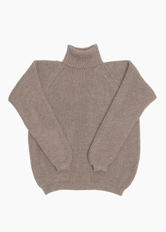 A beige unisex turtleneck sweater made of baby alpaca wool with a fisherman rib design.