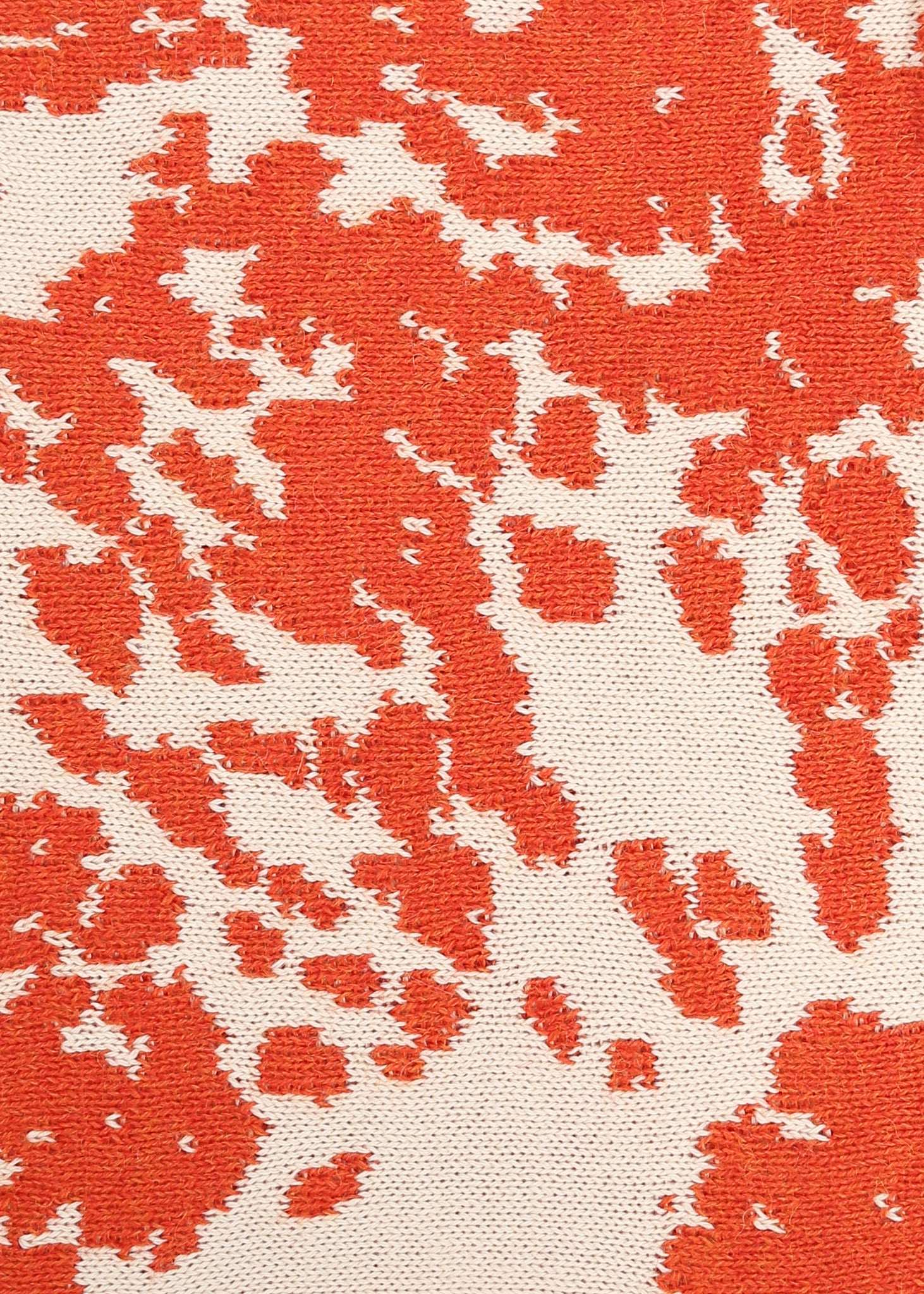 Orange and cream cow patterned knit