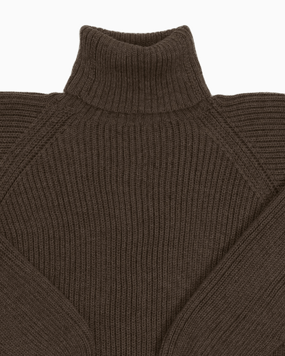Collar detail of a dark brown unisex turtleneck sweater made of baby alpaca wool with a fisherman rib design.