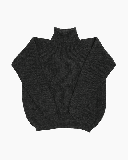 Packshot of a dark grey unisex turtleneck sweater made of baby alpaca wool with a fisherman rib design.