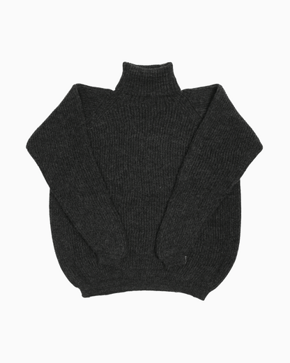 Packshot of a dark grey unisex turtleneck sweater made of baby alpaca wool with a fisherman rib design.