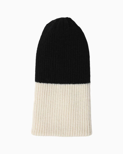 Belacaro kids beanie in black and cream baby alpaca, half-and-half ribbed knit design, flat lay on white background.