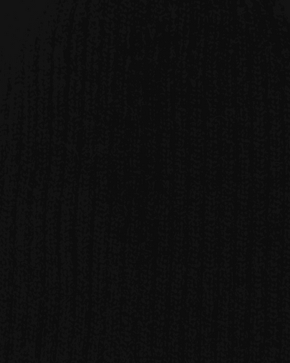 Close-up of the Belacaro kids beanie in black baby alpaca, showing the ribbed knit texture and soft wool fibers.