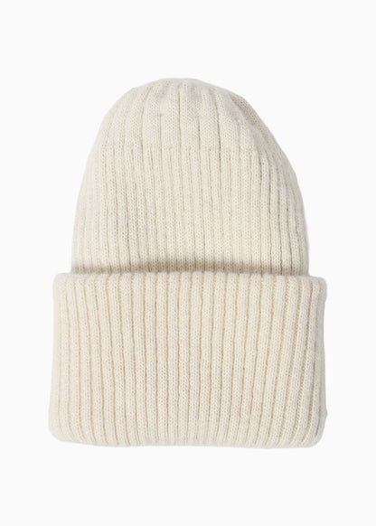 Belacaro kids beanie in cream baby alpaca, ribbed knit with folded brim, cozy and soft texture, flat lay on white background.
