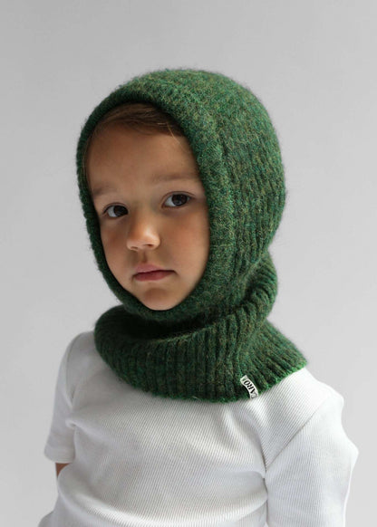 Portrait of a kid wearing a green balaclava against a white background