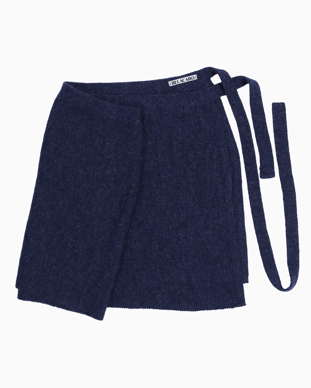 A navy knit pareo skirt over a white background