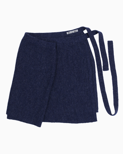 A navy knit pareo skirt over a white background