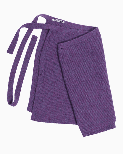 Packshot of a purple knit pareo skirt over white background