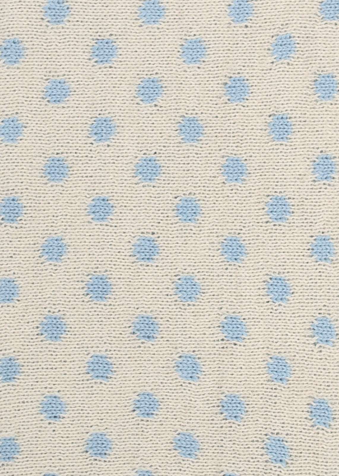 Patterned knit fabric with light blue dots on a beige background