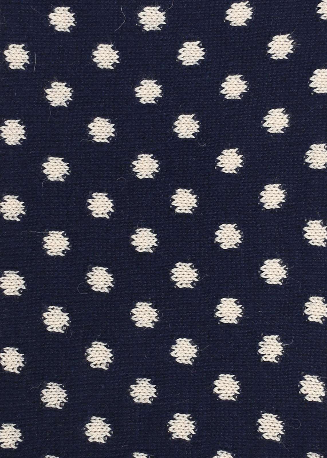 Navy blue knitted fabric with white polka dots