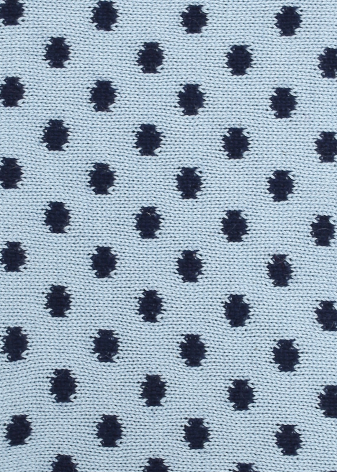 Patterned knit fabric with navy dots on a light blue background