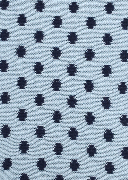 Patterned knit fabric with navy dots on a light blue background