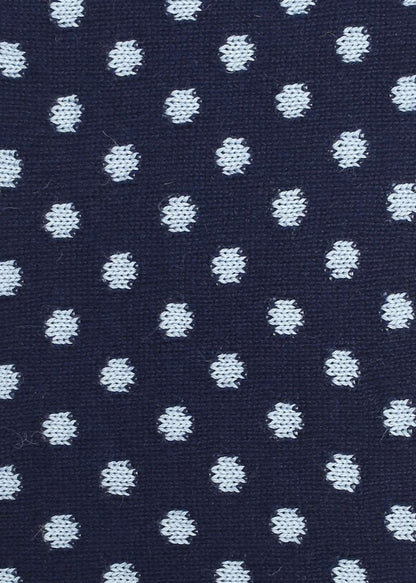 Patterned knit fabric with light blue dots on a navy background