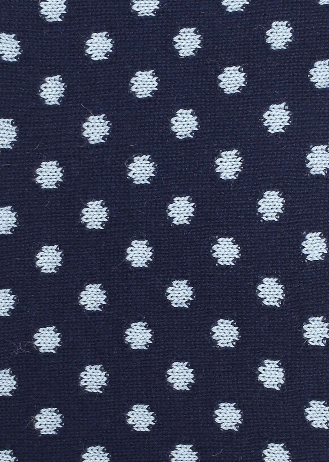 Patterned knit fabric with light blue dots on a navy background
