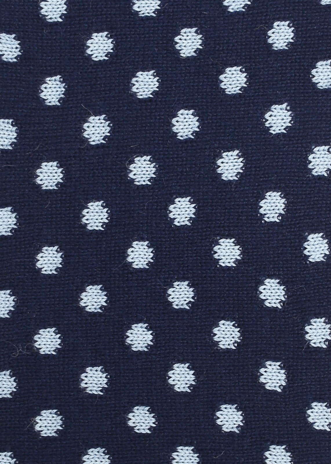 Patterned knit fabric with light blue dots on a navy background