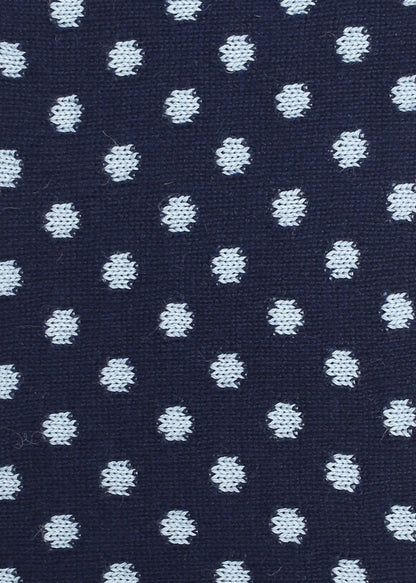 Patterned knit fabric with light blue dots on a navy background