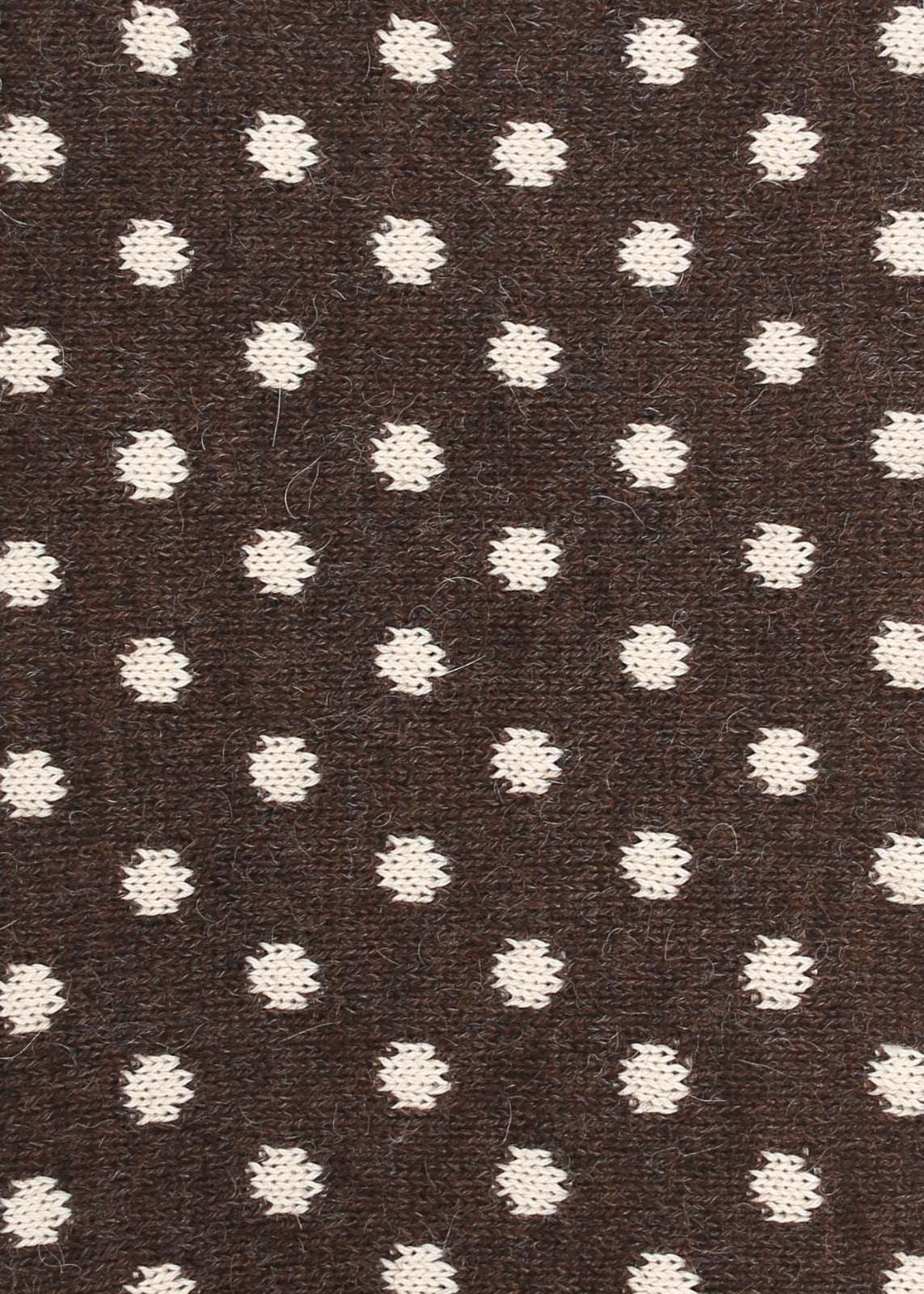 Patterned knit fabric with cream dots on a brown background