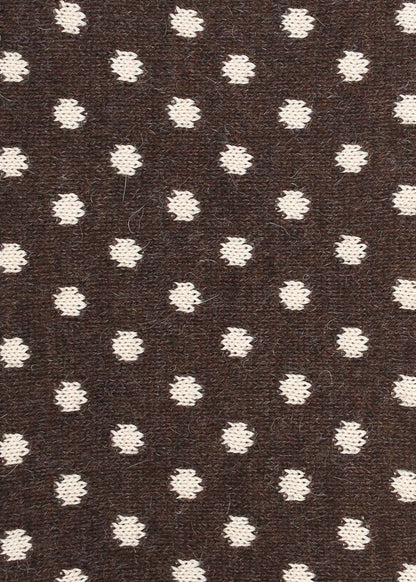 Patterned knit fabric with cream dots on a brown background