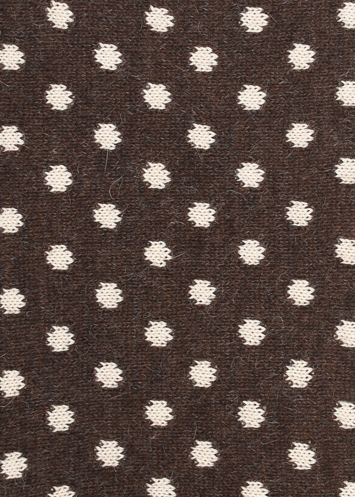 Patterned knit fabric with cream dots on a brown background