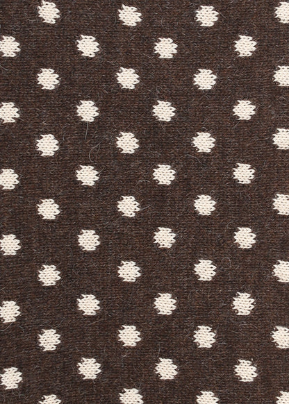 Patterned knit fabric with cream dots on a brown background
