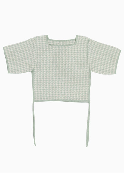 Green knitted checked top on a white background