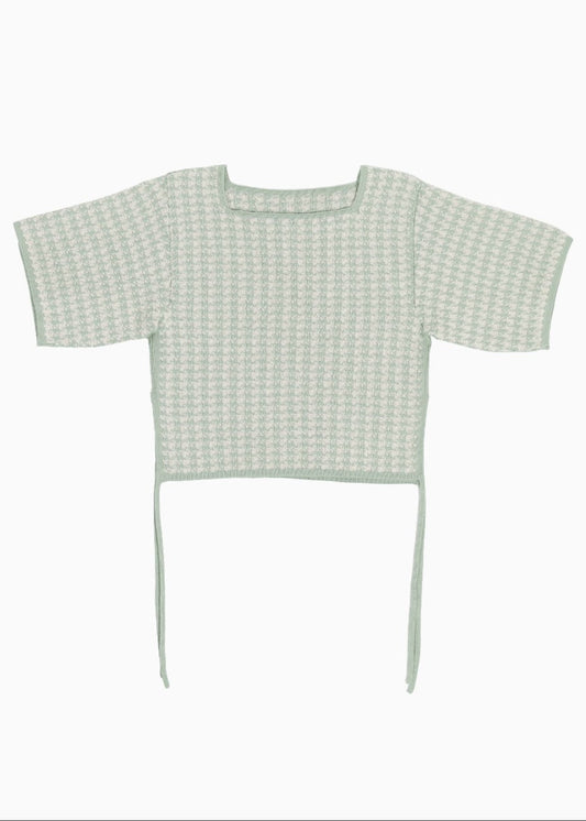 Green knitted checked top on a white background