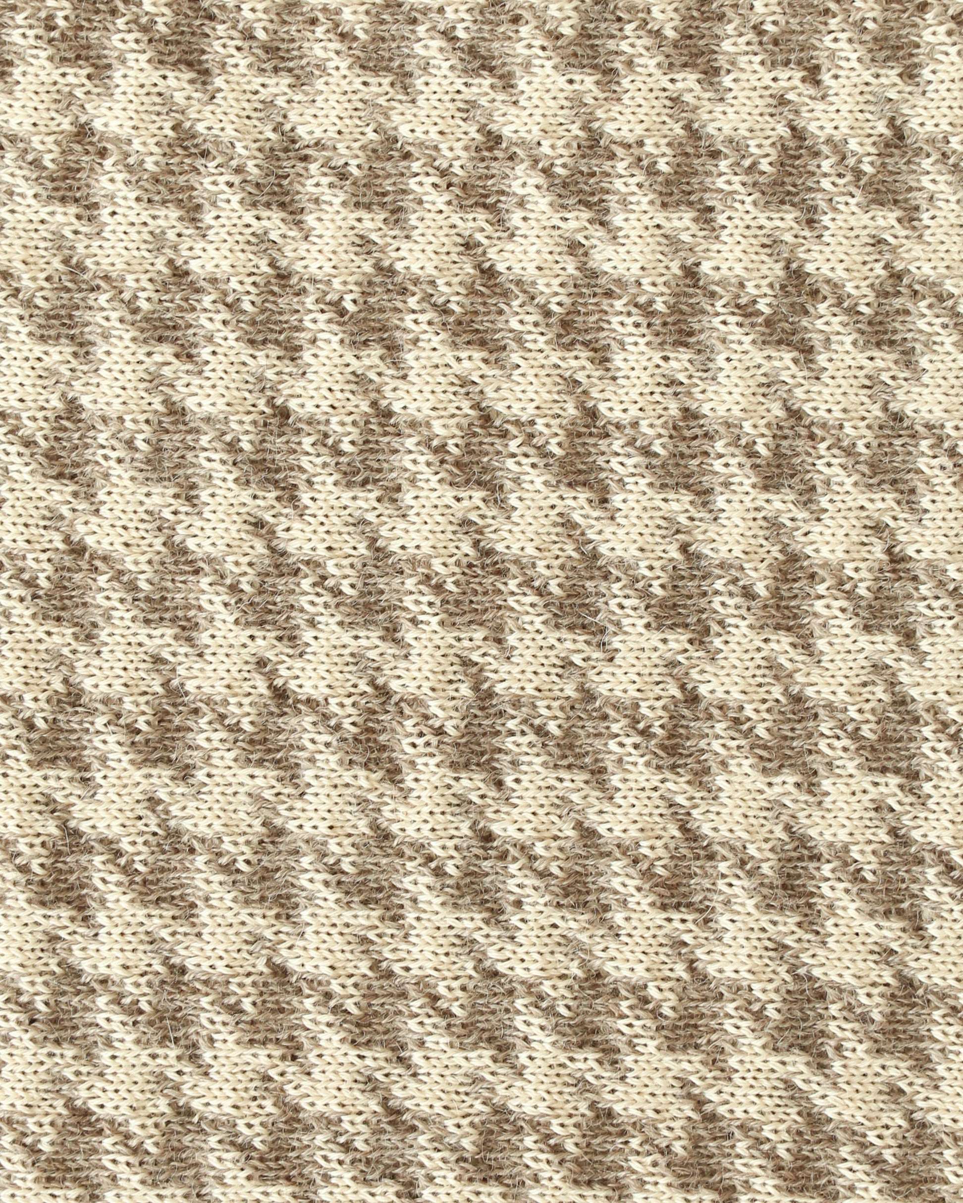 Close-up of a knit with beige and brown houndstooth.