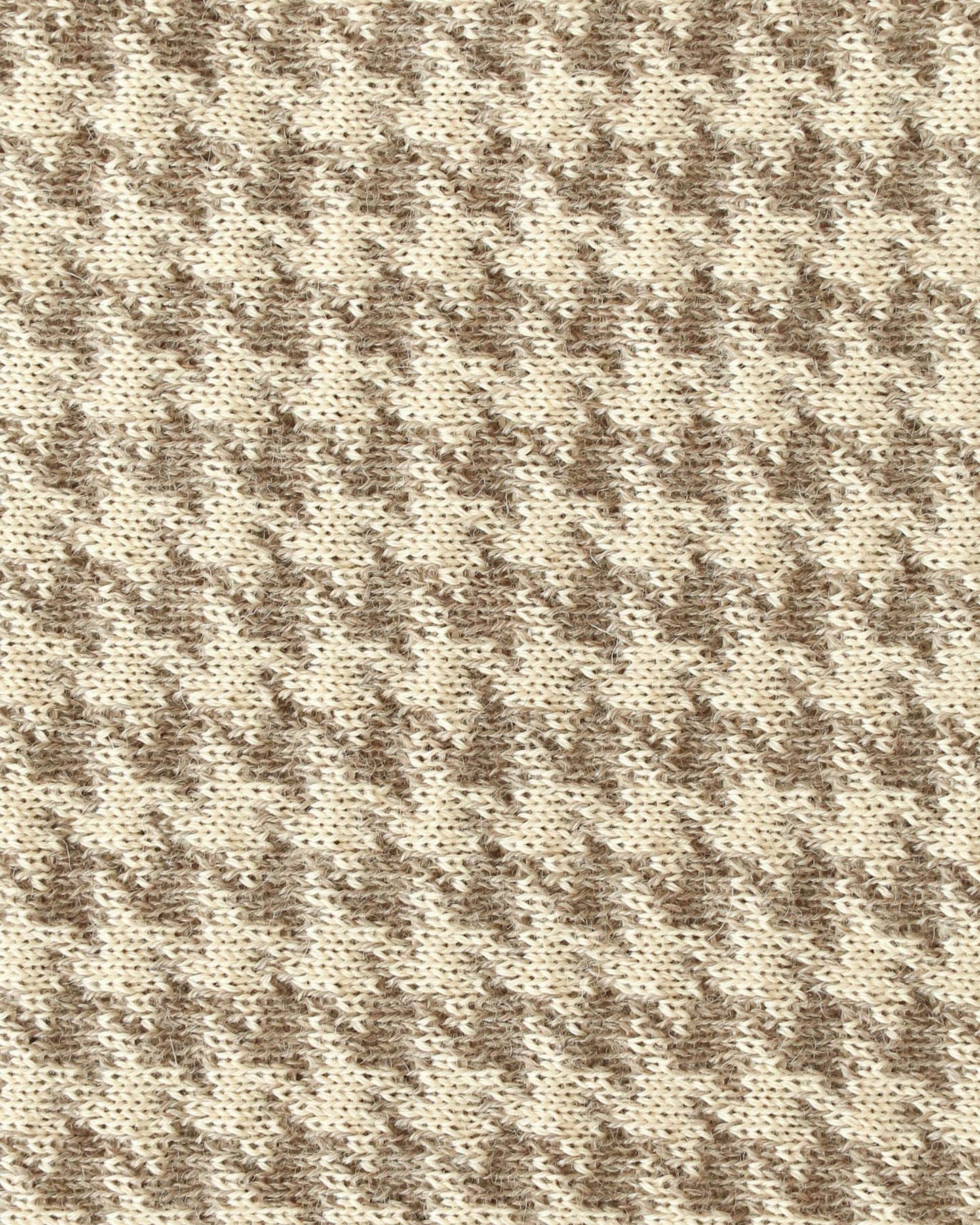 Close-up of a knit with beige and brown houndstooth.