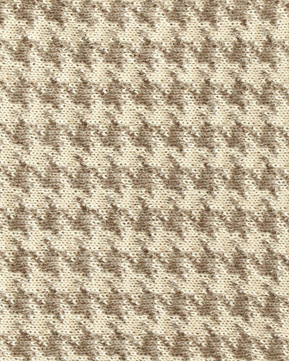 Close-up of a knit with beige and brown houndstooth.