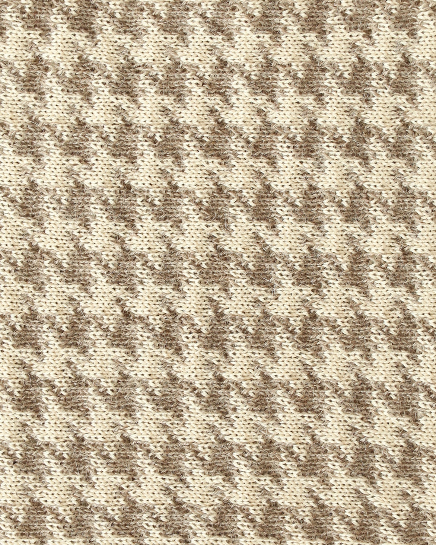 Close-up of a knit with beige and brown houndstooth.