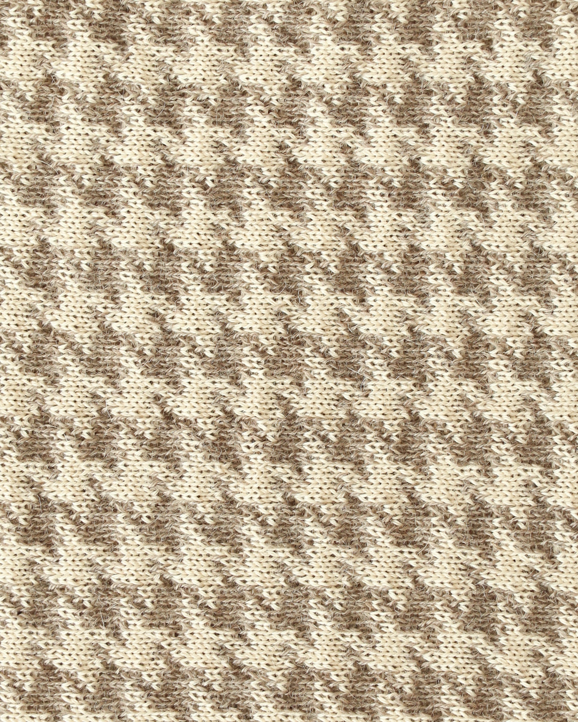 Close-up of a knit with beige and brown houndstooth.