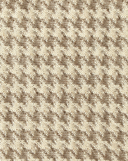 Close-up of a knit with beige and brown houndstooth.