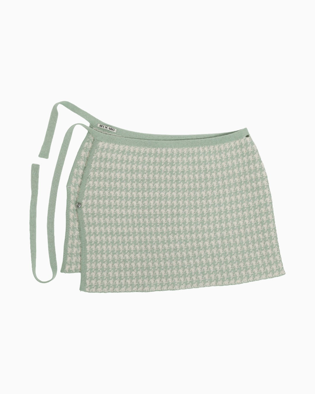 Green and white houndtooth knitted pareo skirt on a white background