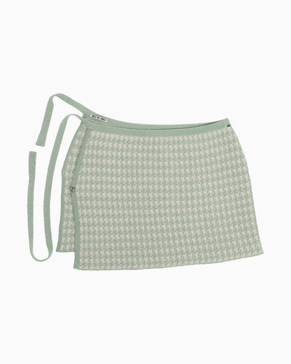 Green and white houndtooth knitted pareo skirt on a white background