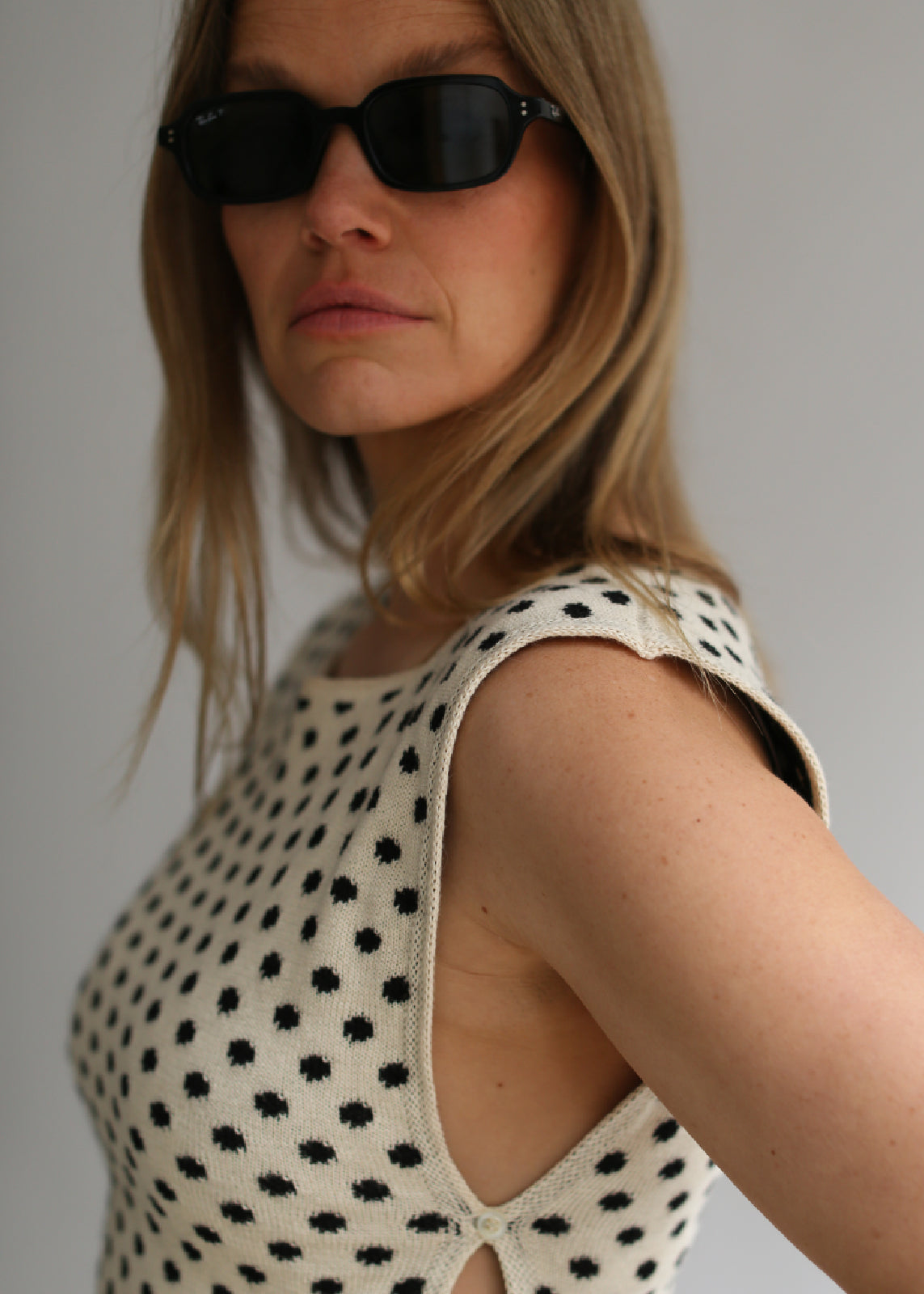 Model wearing a polka dot knitted top black and white