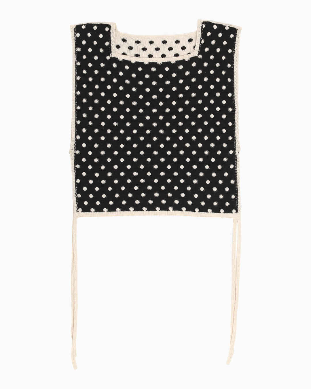 Black polka dot apron top with white trim on a white background