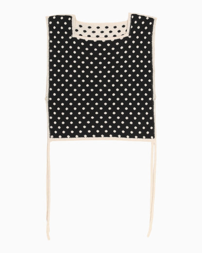 Black polka dot apron top with white trim on a white background