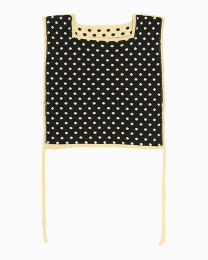 Black and yellow polka dot apron top with white trim on a white background